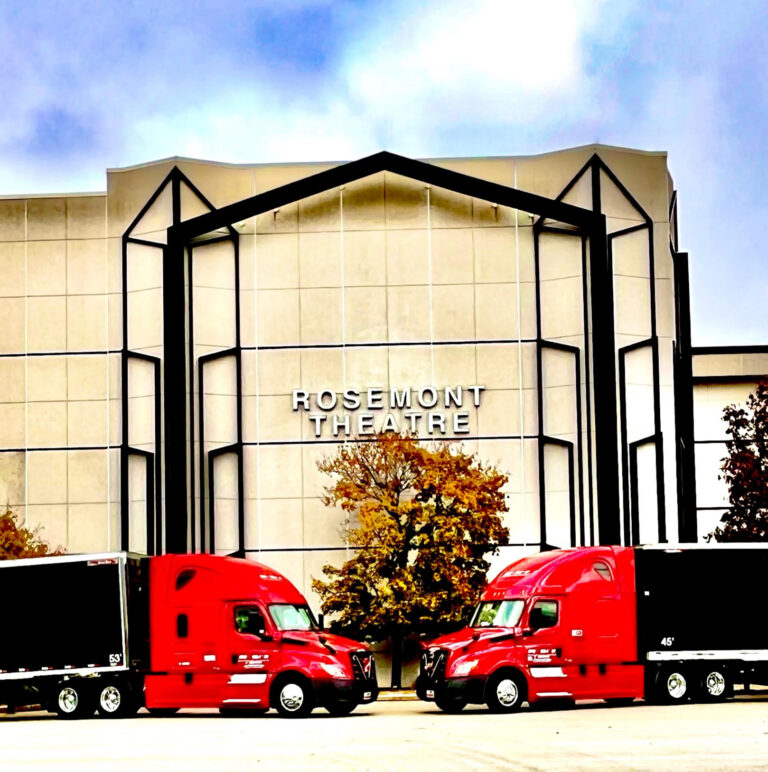 red semi trucks in front of Rosemont Theatre