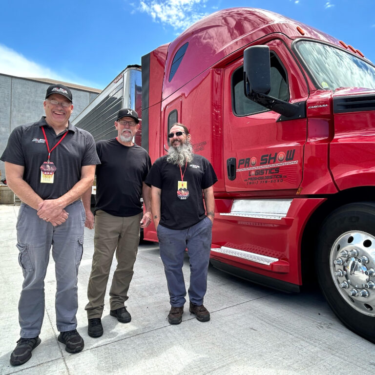 employees standing in front of red semi-truck