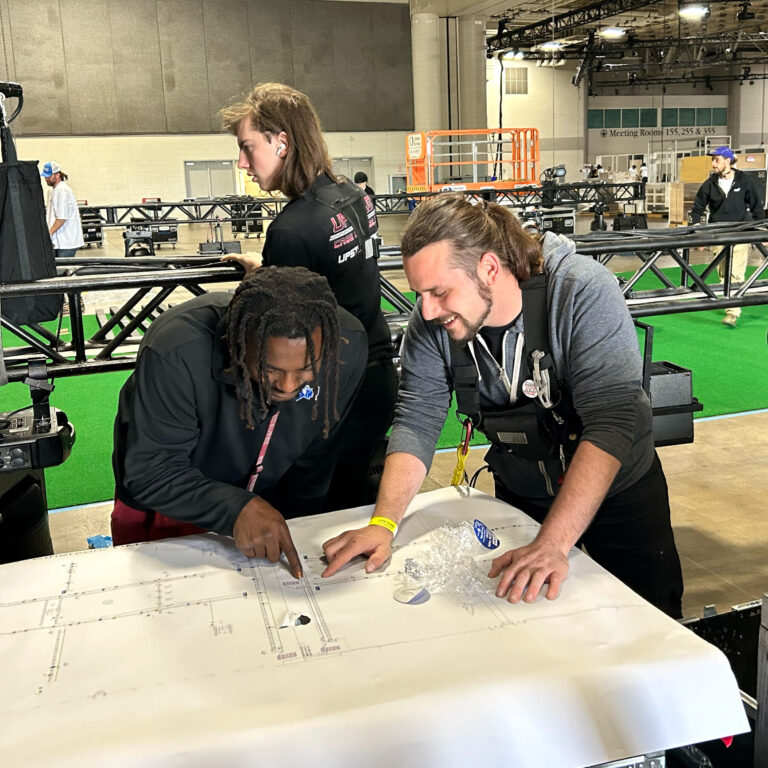 upstage employees looking at blueprints