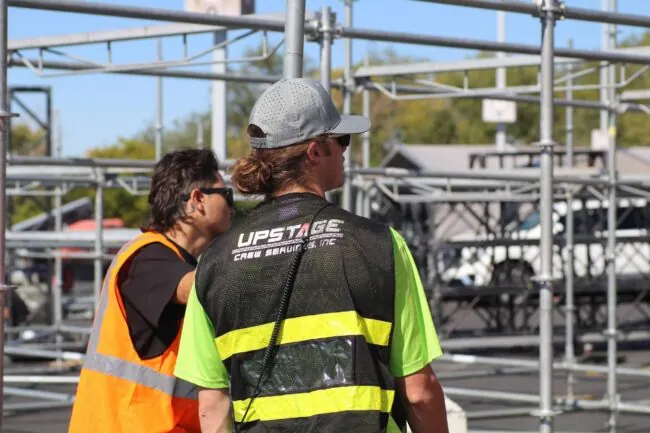 Upstage Companies crew lead Kelton Bass directing stage scaffolding build for stage production at Breakaway Utah